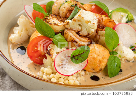 Portion of dish with ptitim and seafood Portion of dish with ptitim and seafood 103755983