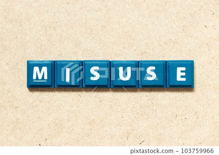 Tile alphabet letter in word misuse on wood background 103759966