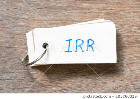 Flash card with handwriting in word IRR (Abbreviation of internal rate of return) on wood background 103760029
