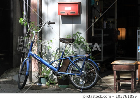 Bicycle and old stool placed in front of an antique store, morning scenery Bicycle and old stool placed in front of an antique store, morning scenery 103761859