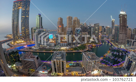 Panoramic view of Dubai Marina with several boat and yachts parked in harbor and skyscrapers around canal aerial day to night timelapse. Panoramic view of Dubai Marina with several boat and yachts parked in harbor and skyscrapers around canal aerial day to night timelapse. 103762721