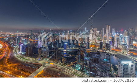 Skyline with modern architecture of Dubai business bay towers day to night timelapse. Aerial view 103762830