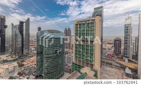 Panorama showing Dubai international financial center skyscrapers with promenade on a gate avenue aerial timelapse. Panorama showing Dubai international financial center skyscrapers with promenade on a gate avenue aerial timelapse. 103762841