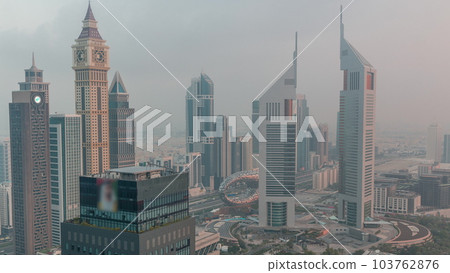 Skyscrapers on Sheikh Zayed Road and DIFC night to day timelapse in Dubai, UAE. 103762876