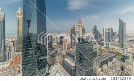 Panorama showing futuristic skyscrapers in financial district business center in Dubai on Sheikh Zayed road timelapse 103762879