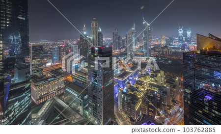 Panorama of futuristic skyscrapers after sunset in financial district business center in Dubai day to night timelapse 103762885