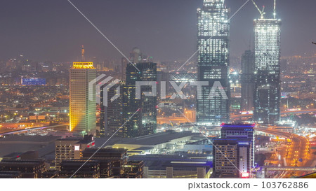 Aerial view of skyscrapers with World Trade center in Dubai day to night timelapse. Aerial view of skyscrapers with World Trade center in Dubai day to night timelapse. 103762886