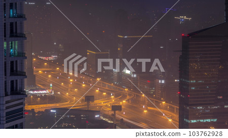 Dubai Aerial view showing al barsha heights and greens district area night timelapse Dubai Aerial view showing al barsha heights and greens district area night timelapse 103762928