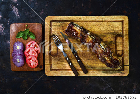 Roasted beef ribs presented on the table, Patagonia, Argentina. Roasted beef ribs presented on the table, Patagonia, Argentina. 103763552
