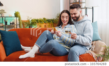 Family man woman using credit bank card and smartphone, transferring money purchases online shopping Family man woman using credit bank card and smartphone, transferring money purchases online shopping 103764269