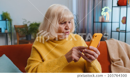 Sad grandmother woman use smartphone surprised by bad news fortune loss fail lottery result deadline Sad grandmother woman use smartphone surprised by bad news fortune loss fail lottery result deadline 103764300