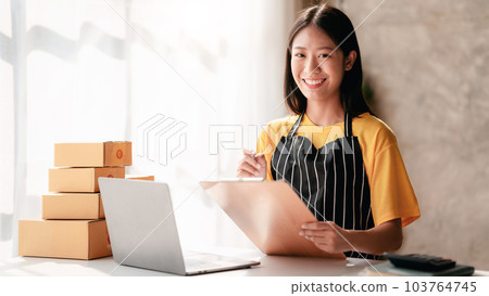 Small business parcel delivery concept, Female entrepreneur writ Small business parcel delivery concept, Female entrepreneur writ 103764745