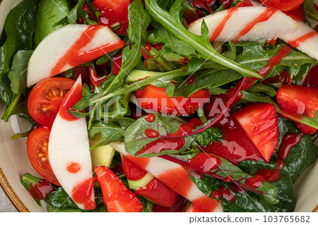 Portion of salad with strawberry and greens 103765682