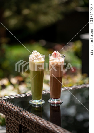 Portion of green and chocolate matcha latte 103765729