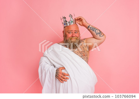 Funny man acts like an important king with a crown above the head Funny man acts like an important king with a crown above the head 103766094