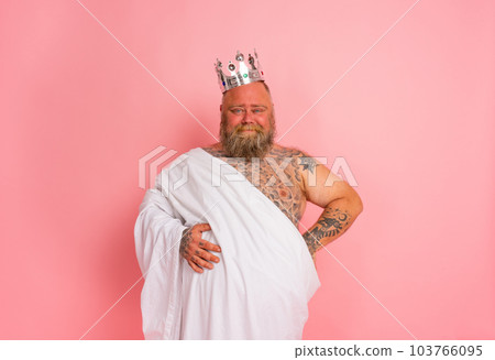 Funny man acts like an important king with a crown above the head Funny man acts like an important king with a crown above the head 103766095