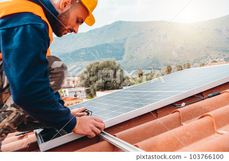 Workers assemble energy system with solar panel for electricity and hot water 103766100