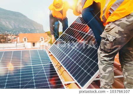 Workers assemble energy system with solar panel for electricity and hot water 103766107