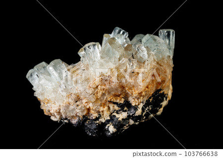 Macro mineral stone crystals Aquamarine in rock on a black background 103766638