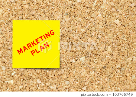 Yellow note paper with word marketing plan on cork board background with copy space Yellow note paper with word marketing plan on cork board background with copy space 103766749