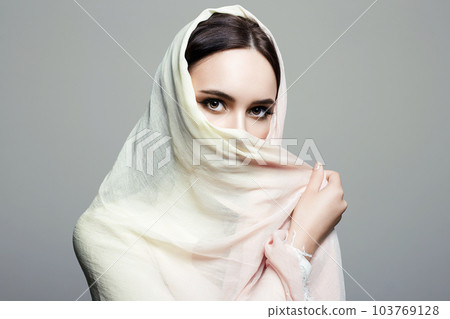 beautiful young woman covered her face in hijab 103769128