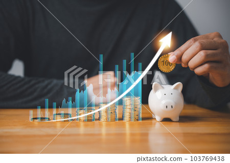 Financial planning for the future - businessman saving money in a pink piggy bank while monitoring stock market growth with a digital chart. Concept of investing, retirement, and wealth creation. Financial planning for the future - businessman saving money in a pink piggy bank while monitoring stock market growth with a digital chart. Concept of investing, retirement, and wealth creation. 103769438