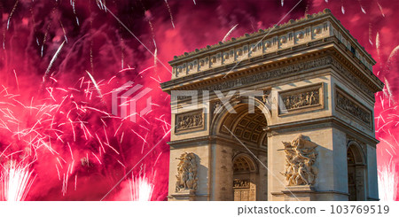 Celebratory colorful fireworks over the Arc de Triomphe, Paris, France. The walls of the arch are engraved with the names of 128 battles and names of 660 French military leaders (in French) 103769519