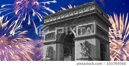 Celebratory colorful fireworks over the Arc de Triomphe, Paris, France. The walls of the arch are engraved with the names of 128 battles and names of 660 French military leaders (in French) 103769560
