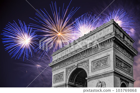 Celebratory colorful fireworks over the Arc de Triomphe, Paris, France. The walls of the arch are engraved with the names of 128 battles and names of 660 French military leaders (in French) 103769868