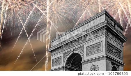 Celebratory colorful fireworks over the Arc de Triomphe, Paris, France. The walls of the arch are engraved with the names of 128 battles and names of 660 French military leaders (in French) 103769893