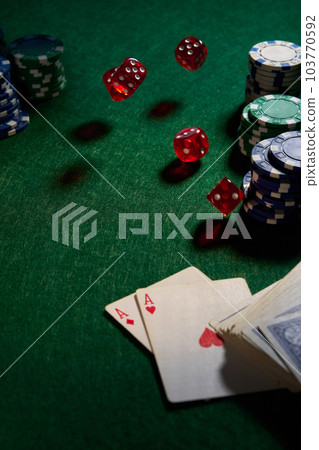 dice chips on green cloth for poker 103770592