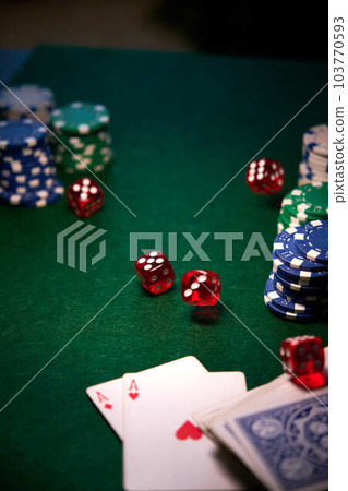 dice chips on green cloth for poker 103770593