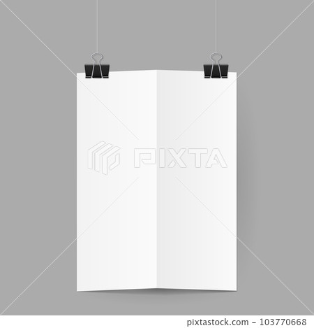 White sheet of paper folded in half handing on black binder clips 103770668