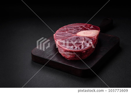 Fresh beef ossobuco steak with salt, spices and herbs 103771609