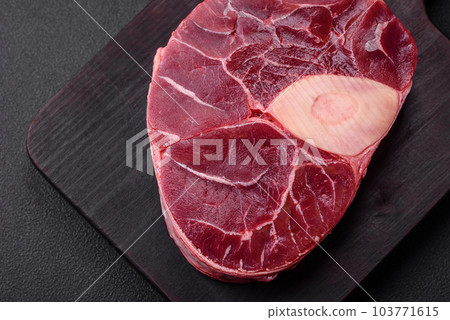 Fresh beef ossobuco steak with salt, spices and herbs Fresh beef ossobuco steak with salt, spices and herbs 103771615