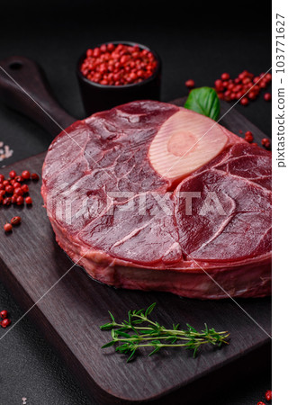 Fresh beef ossobuco steak with salt, spices and herbs 103771627