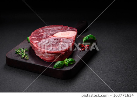 Fresh beef ossobuco steak with salt, spices and herbs 103771634