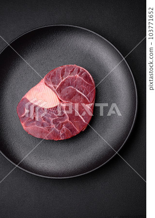 Fresh beef ossobuco steak with salt, spices and herbs Fresh beef ossobuco steak with salt, spices and herbs 103771652