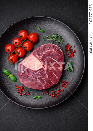 Fresh beef ossobuco steak with salt, spices and herbs Fresh beef ossobuco steak with salt, spices and herbs 103771658