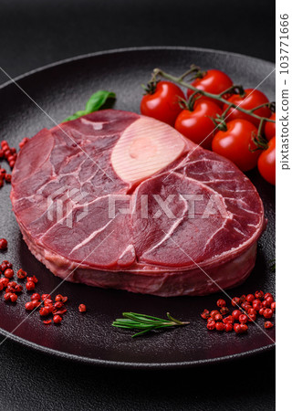 Fresh beef ossobuco steak with salt, spices and herbs 103771666