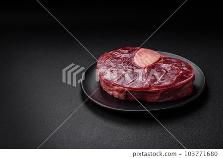 Fresh beef ossobuco steak with salt, spices and herbs Fresh beef ossobuco steak with salt, spices and herbs 103771680
