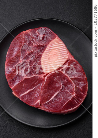Fresh beef ossobuco steak with salt, spices and herbs 103771686