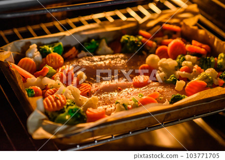 Raw sea bass fish fillet with salt, spices and vegetables in a baking dish Raw sea bass fish fillet with salt, spices and vegetables in a baking dish 103771705