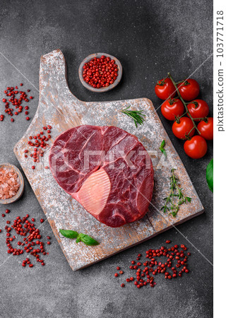 Fresh beef ossobuco steak with salt, spices and herbs 103771718
