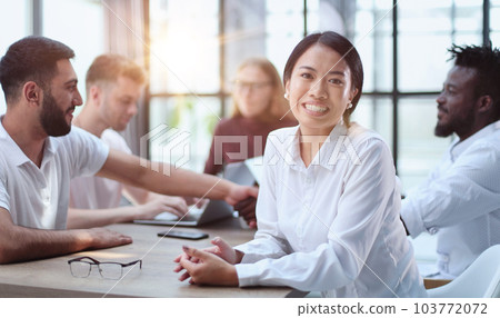 Happy young woman and looking at the camera. Portrait of a smiling businesswoman in the office 103772072
