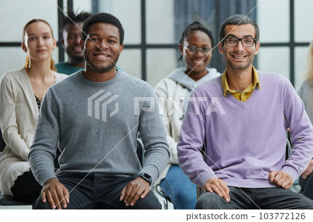 diverse young people sitting on chairs in the conference room. diverse young people sitting on chairs in the conference room. 103772126
