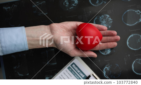 Red heart in the palm of your hand against the background of a medical card. cardiology concept 103772840