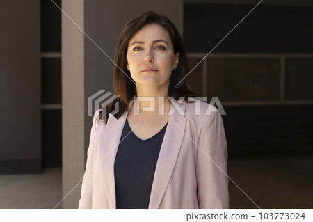 Portrait Confident Mature 40 yo Beautiful Woman, Professional. Intelligent Caucasian Burnette Female With Brown Eyes Looks At Camera, Wears Pink Jackets, Blue Shirt. Horizontal Plane Business Concept Portrait Confident Mature 40 yo Beautiful Woman, Professional. Intelligent Caucasian Burnette Female With Brown Eyes Looks At Camera, Wears Pink Jackets, Blue Shirt. Horizontal Plane Business Concept 103773024