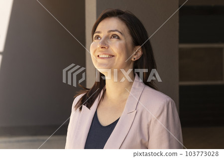 Portrait Happy Mature 40 yo Beautiful Woman Smiling With Teeth. Caucasian Burnette Female With Brown Eyes Looks Up, Wears Pink Jacket, Blue Shirt. Horizontal Plane Portrait Happy Mature 40 yo Beautiful Woman Smiling With Teeth. Caucasian Burnette Female With Brown Eyes Looks Up, Wears Pink Jacket, Blue Shirt. Horizontal Plane 103773028