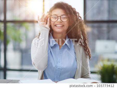 Focused agent girl, lawyer manager, sitting at workplace. 103773412